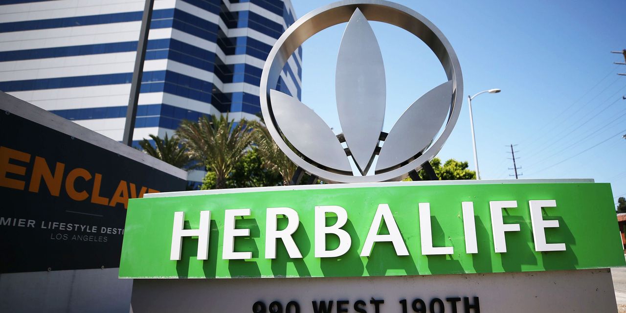 Herbalife puts former CEO back in charge and withdraws guidance; stock slides