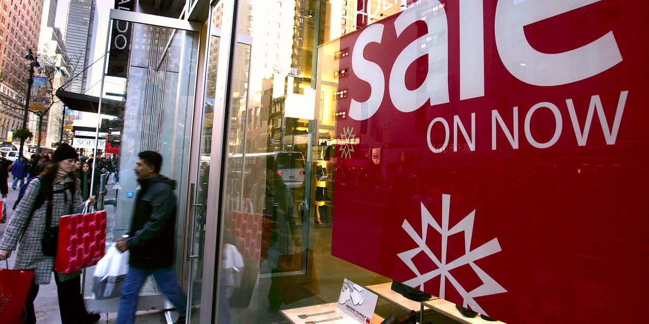 Inflation should send holiday sales to a record high, even as retailers scale back seasonal hires, industry group reports